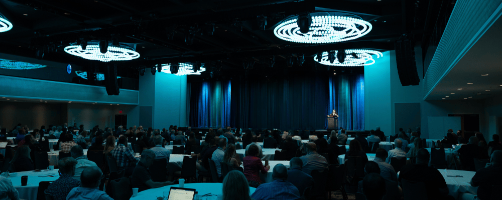 group of event attendees watching a corporate conference presentation