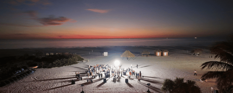Attendees standing at an outdoor event at all-inclusive incentive trip