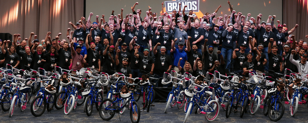 group of event attendees celebrating a bike build activity