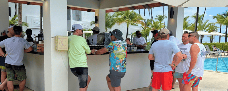 Attendees standing around a bar at an all-inclusive incentive trip