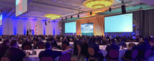 Group of attendees listening to a presentation at a kickoff conference