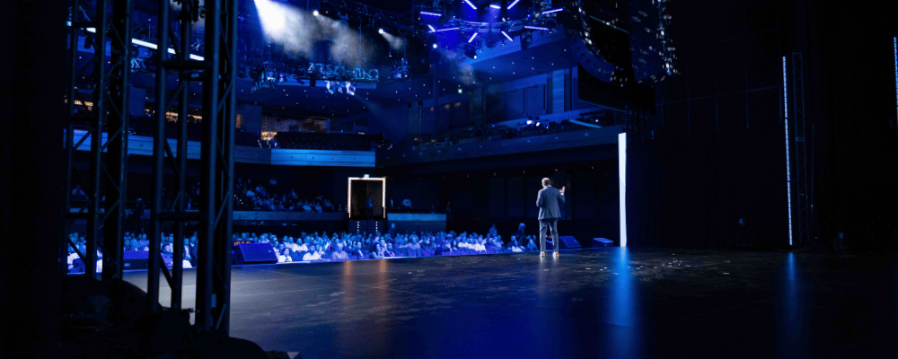 CEO giving a presentation on stage during a corporate event 