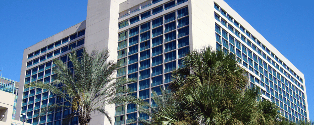 hotel conference venue with palm trees and blue sky
