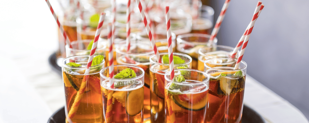 plate of alcoholic drinks being served to event attendees