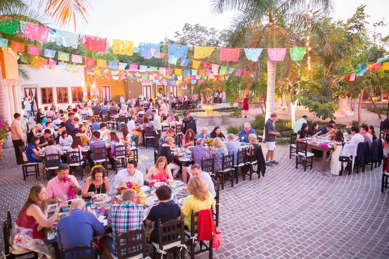 group of people enjoying dinner at a sales incentive trip with mexican-inspired decoration