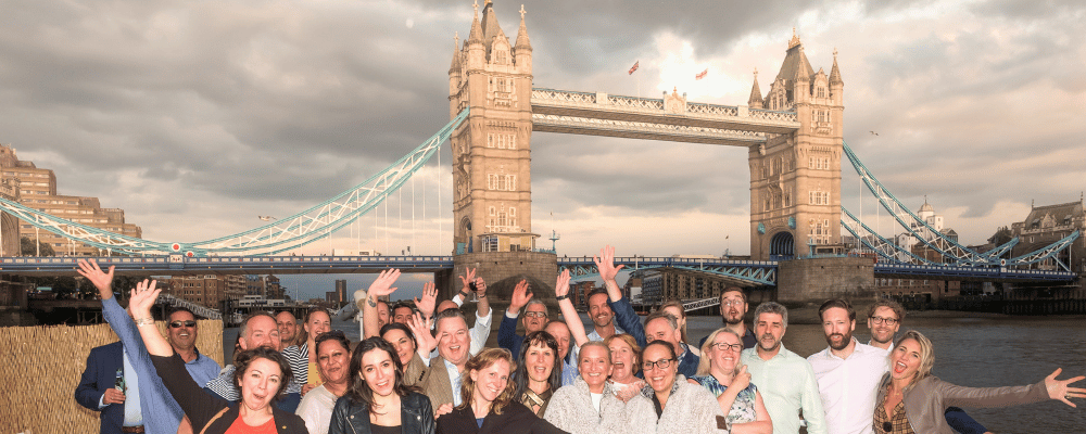 group of event attendees celebrating under the london bridge