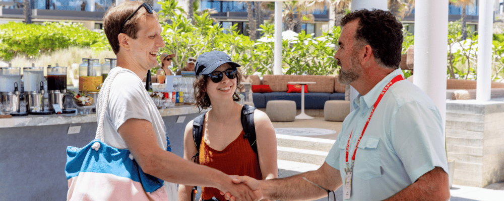 event manager shaking hands with a channel partner during an incentive trip