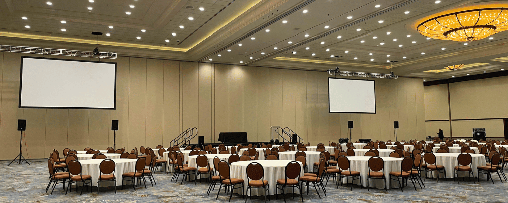 setting up chairs and presentation screens for a corporate event 