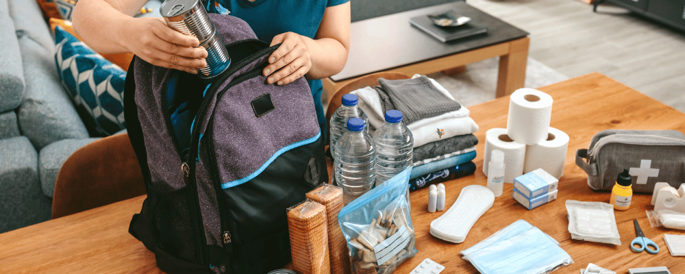 woman packing a comfort kit bag for hospitals