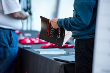 Man holding conference agenda