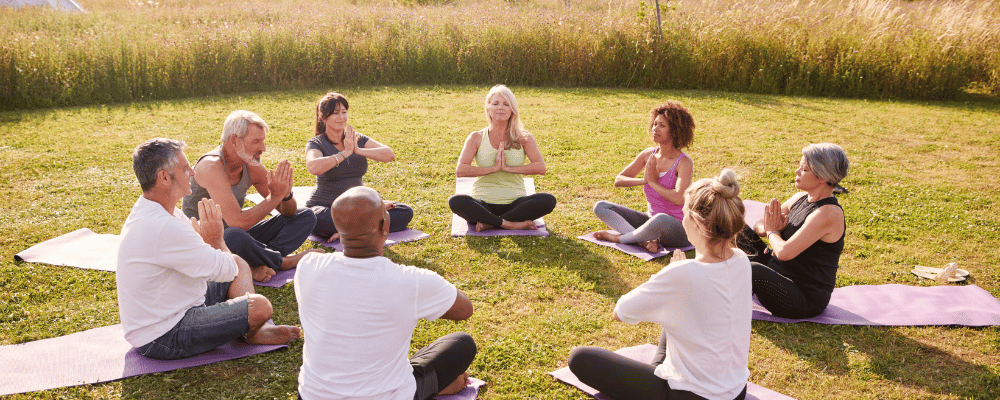 group of executives practicing yoga on a leadership retreat