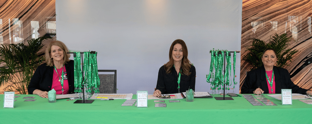 conference employees working the front desk check-in and registration booth