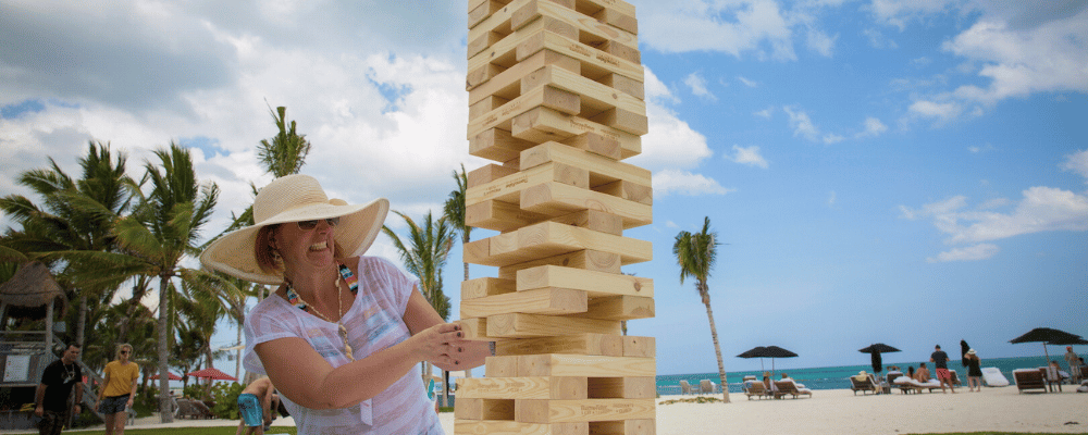 woman playing giant jenga at a corporate incentive trip retreat