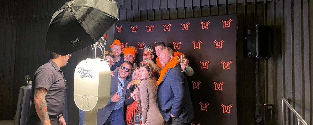 group of event attendees posing for a photo booth