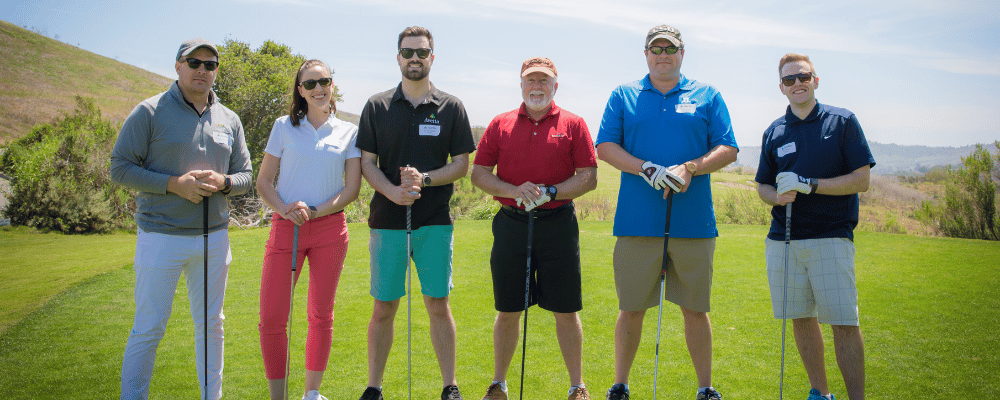 group of event attendees golfing during a conference