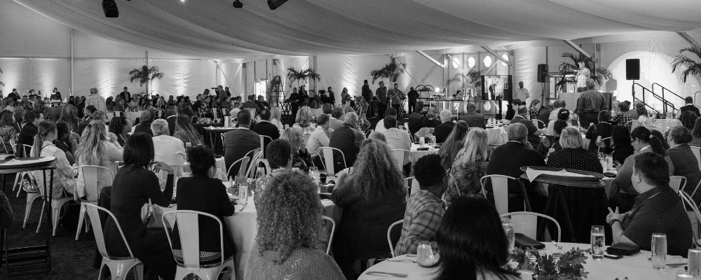 group of event attendees watching a sales presentation