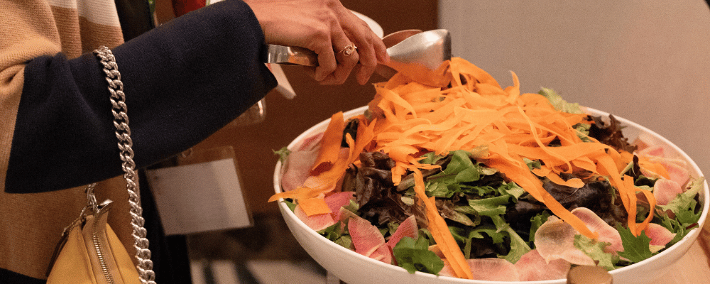 woman getting dinner salad buffet at a conference