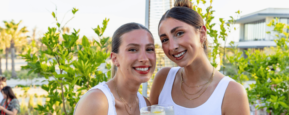 two gen Z woman talking at a conference event