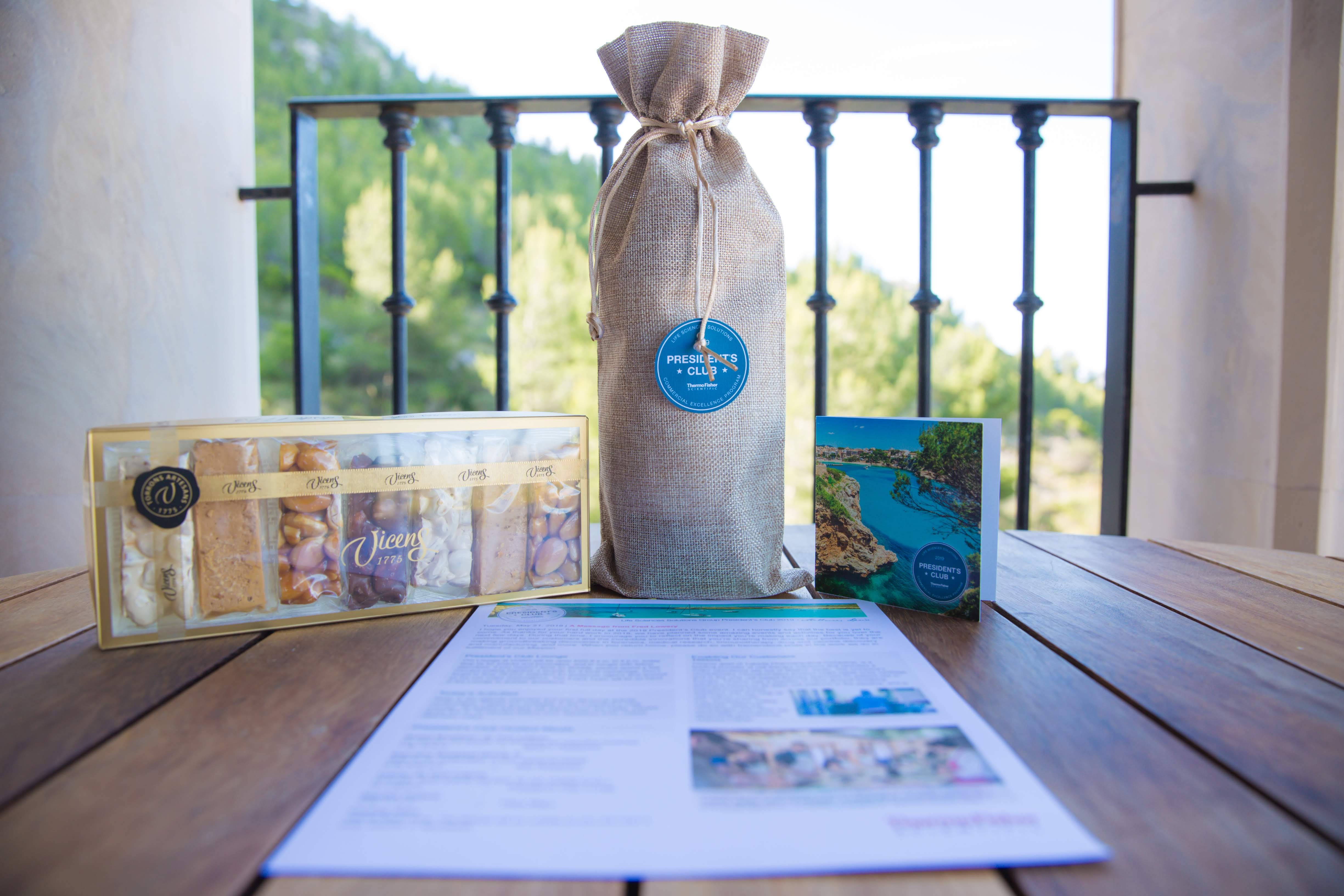 incentive trip event gifting that includes wine bottle in cover, local sweets and card
