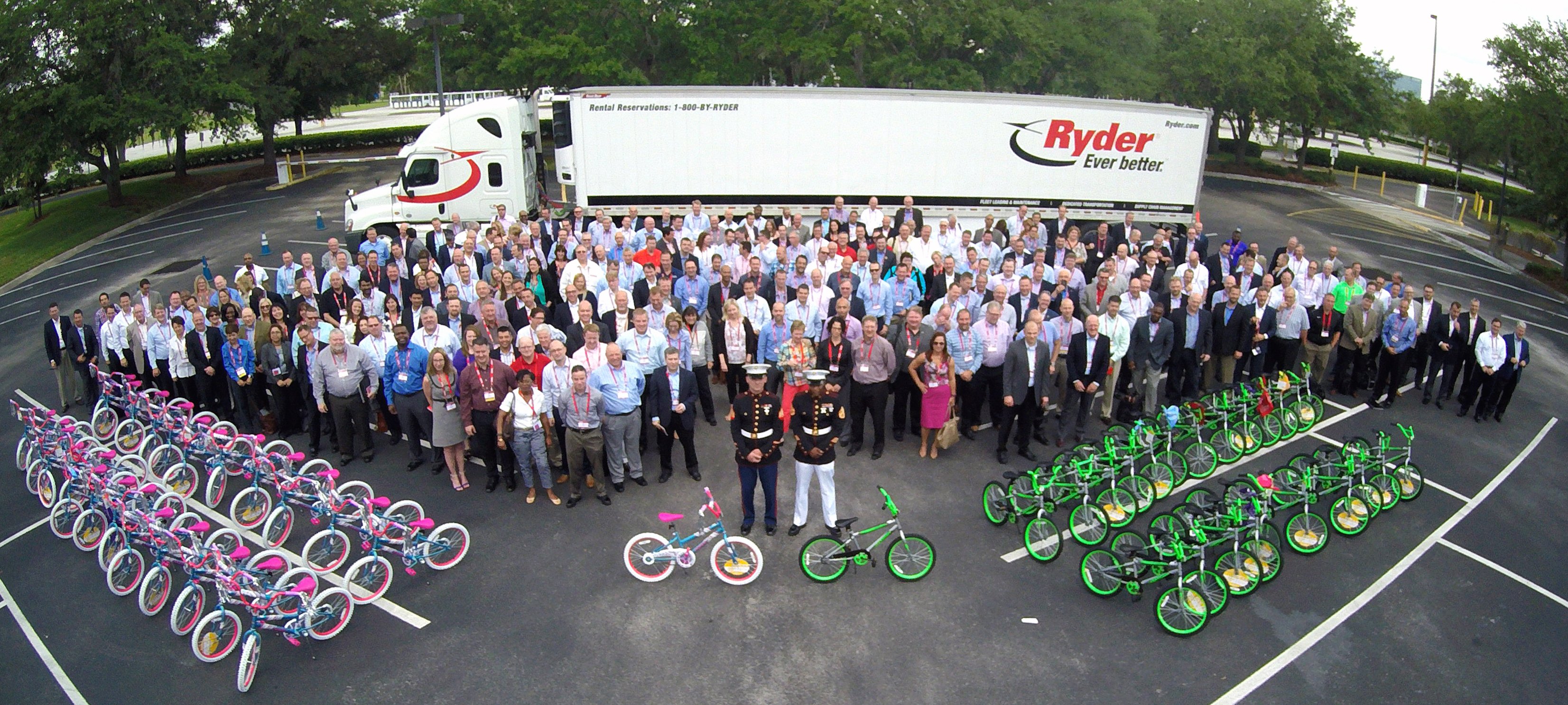 group of people at a Give back event with bikes and a ryder truck