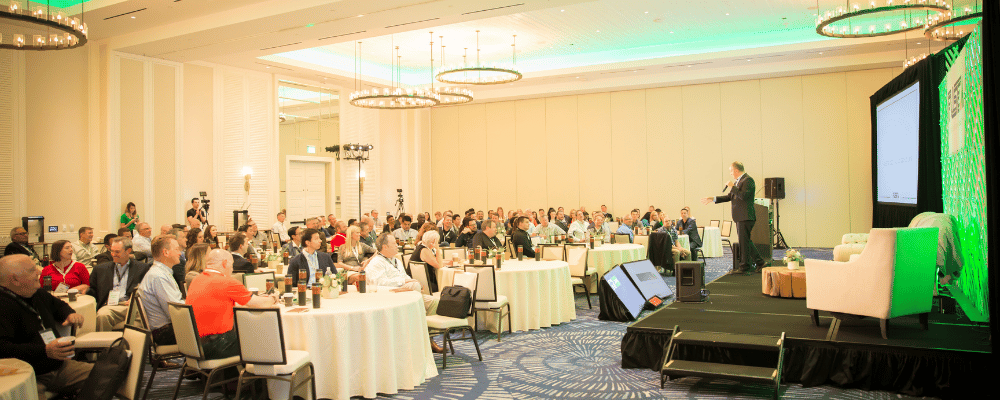 man giving a speech during a corporate conference to attendees 