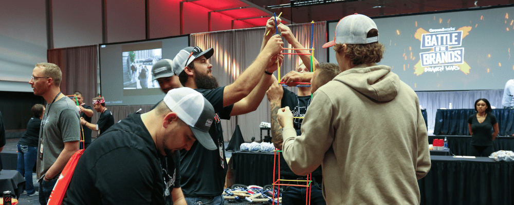 group of attendees racing to build a tower