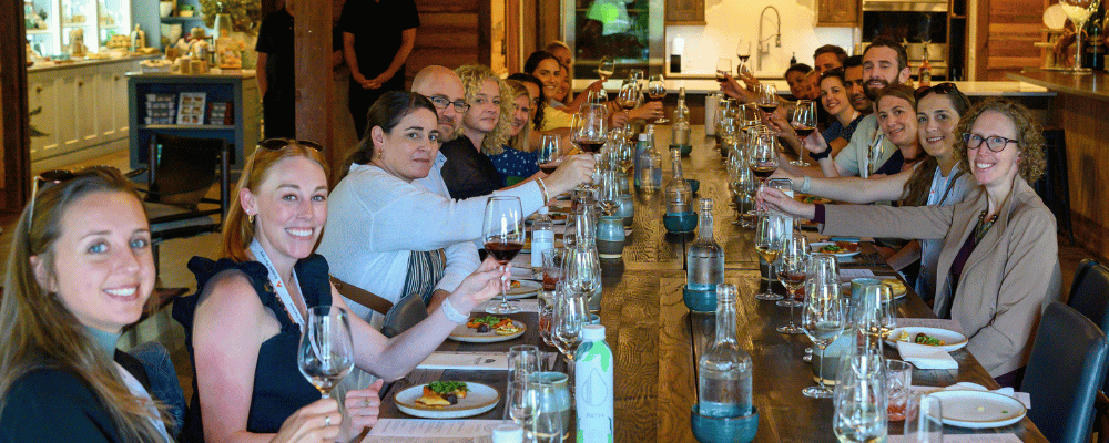 group of event attendees doing a wine tasing activity