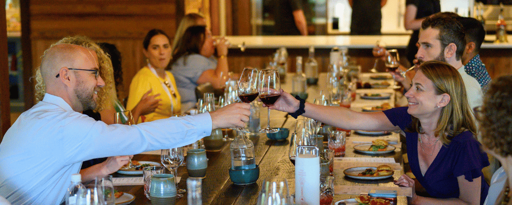 event attendees raising a toast during wine tasting