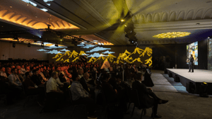 group of attendees sitting in a room for a general session conference
