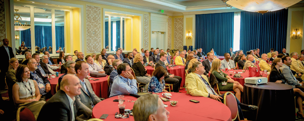 group of attendees watching a presentation during a corporate conference