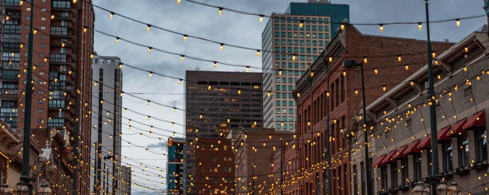 downtown, denver colorado with string lights at dusk