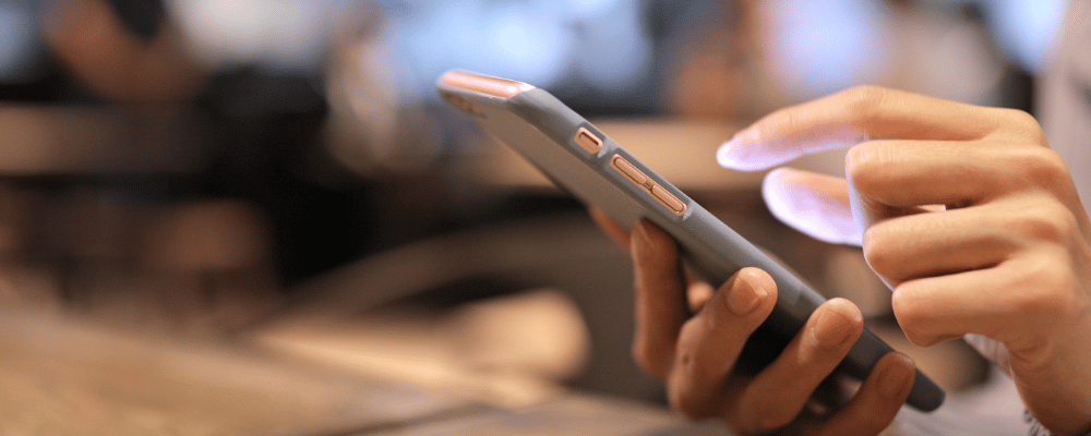 woman on her iphone signing up for an event registration