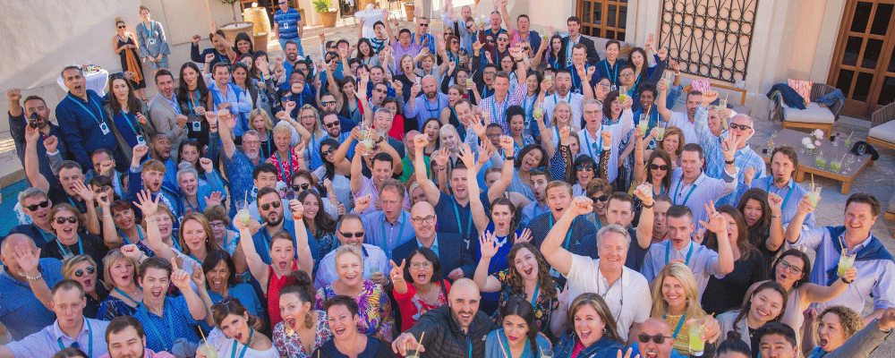 group of attendees celebrating at an international conference