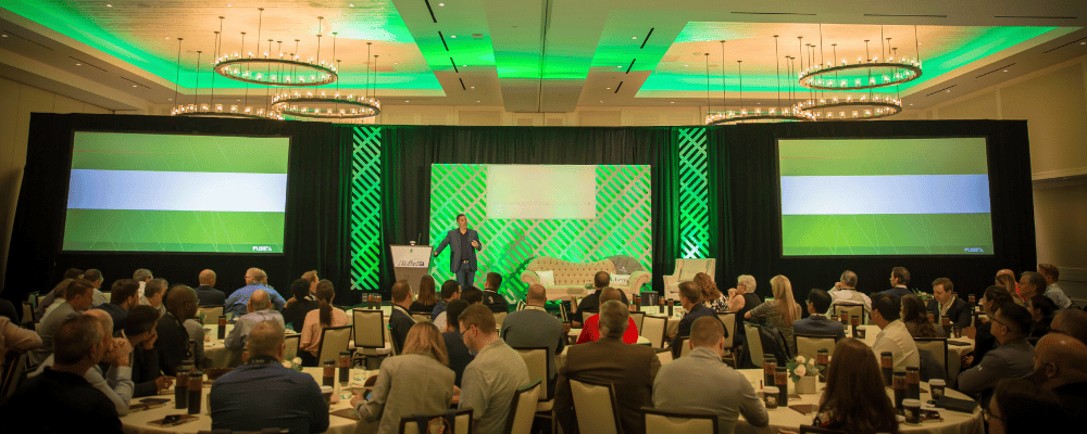 group of attendees listening to a corporate conference presentation