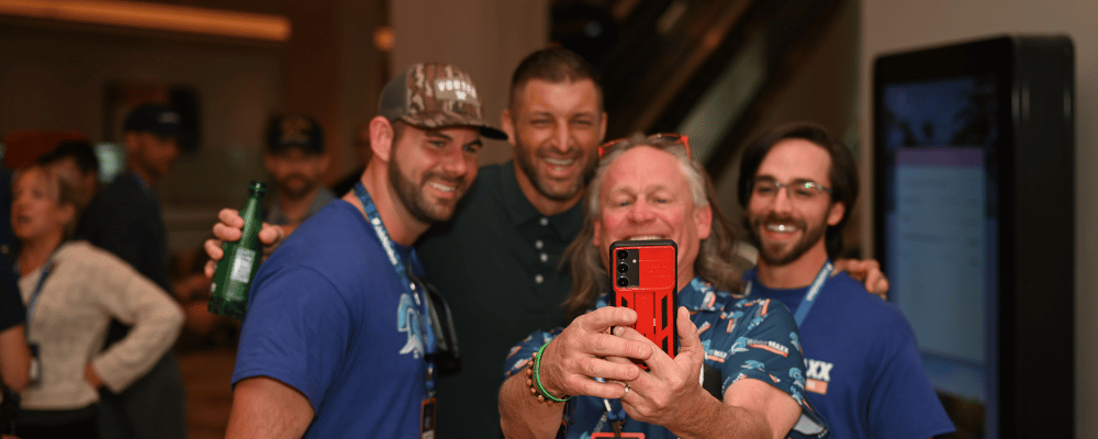 group of attendees taking a selfie at a conference