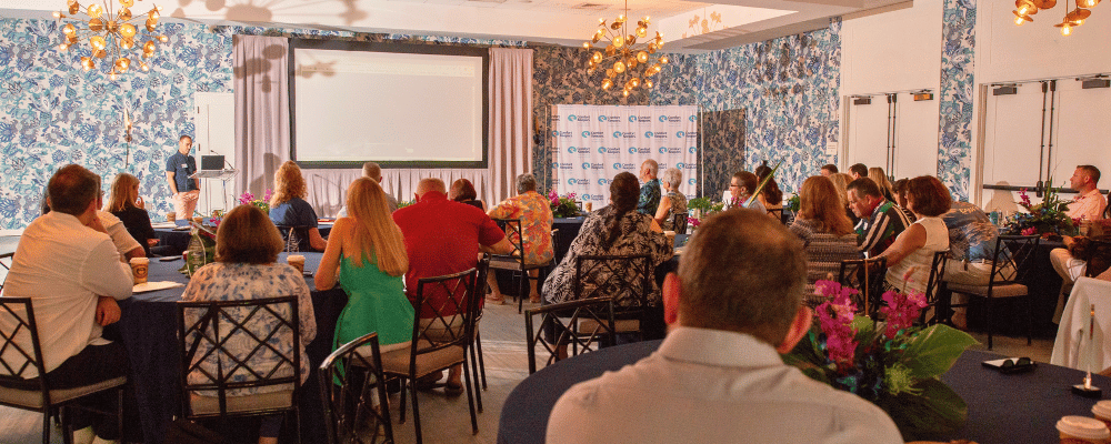 group of event attendees watching a conference presentation