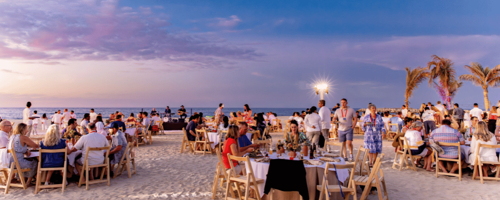 group of conference attendees networking on the beach