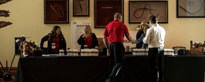 Registration table with people checking in at a conference 