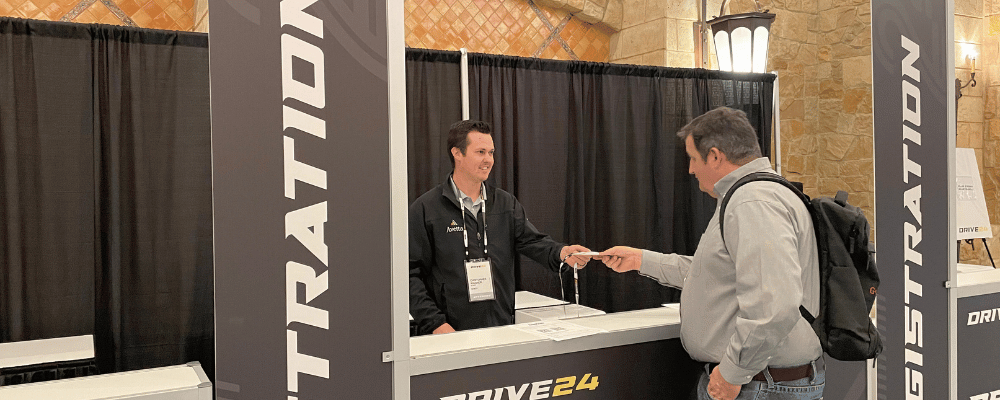 event registration staff checking in an attendee during a conference