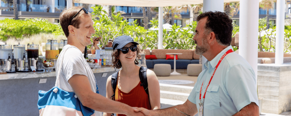 event manager welcoming an attendee during incentive trop registration