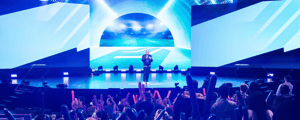 general session with a speaker on stage at a conference 