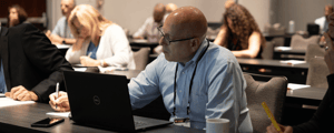 attendee taking notes during a breakout session