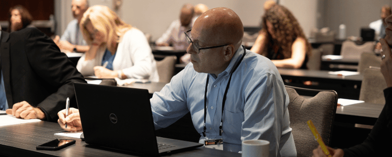 attendee taking notes during a breakout session