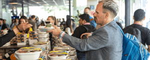 attendee grabbing food during lunch at a corporate event