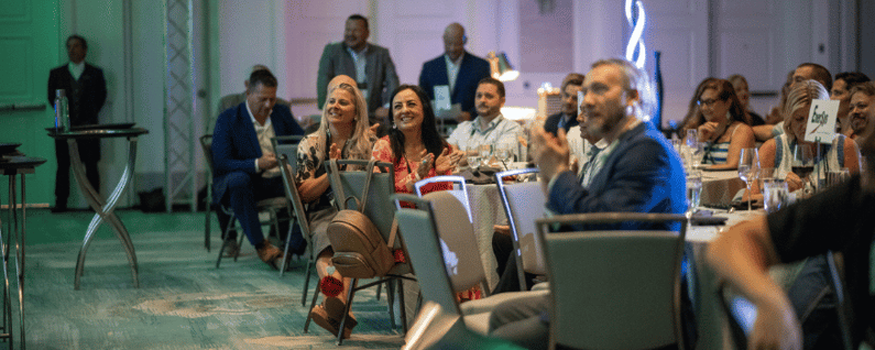 attendees clapping at an award ceremony