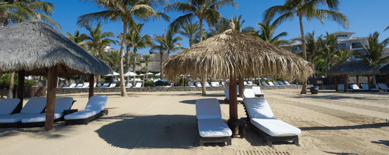 beach side resort with cabanas and layout chairs