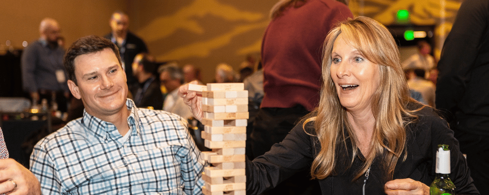 two event attendees playing jenga