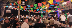 group of attendees at an outdoor dinner in cabo