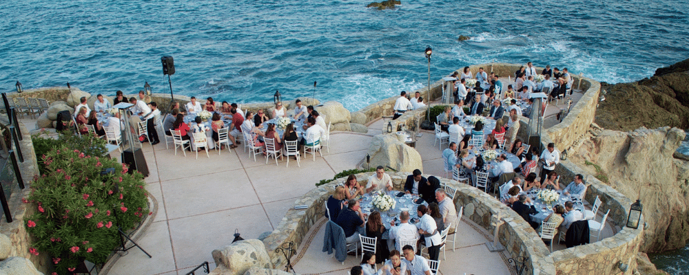 group of people enjoying dinner at an event in cabo san lucas mecixo
