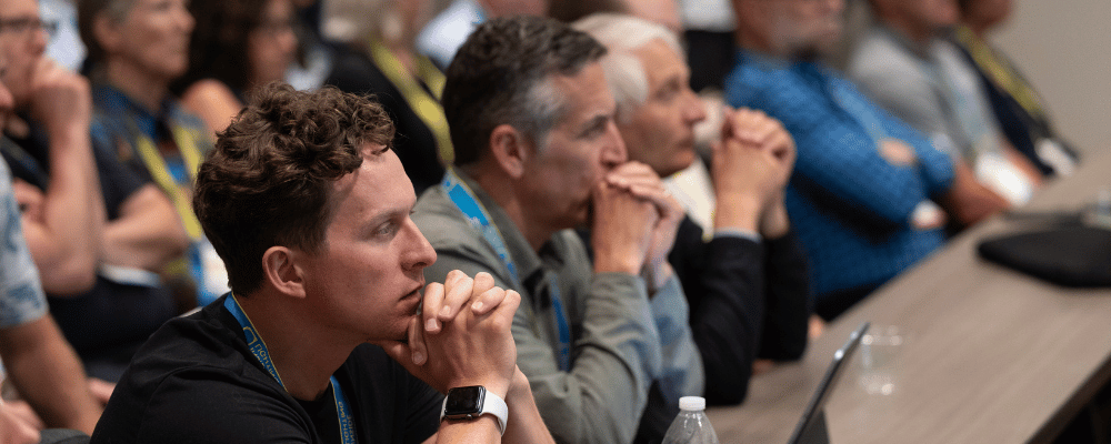 attendee watching a conference presentation